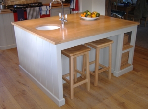 A picture of a painted kitchen island, with polished beech top           